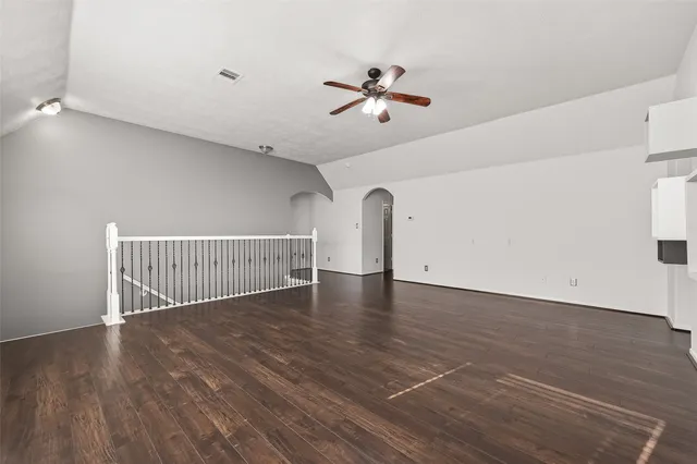a view of a room with wooden floor and fan