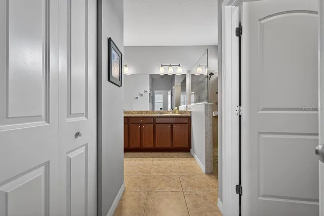 a bathroom with a double vanity sink and a mirror