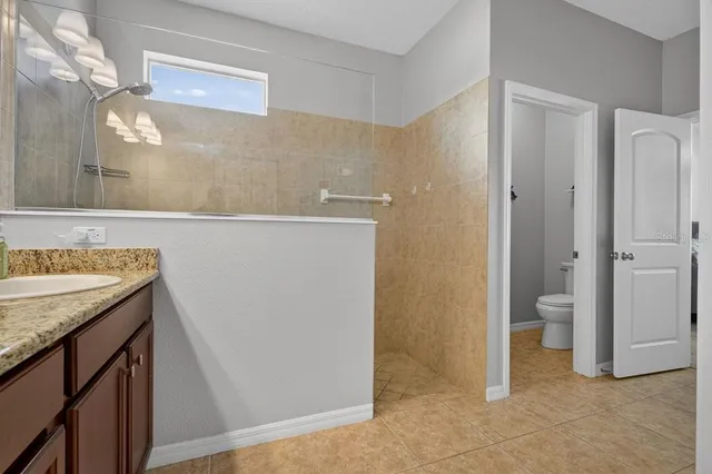 a view of a bathroom with a granite countertop sink