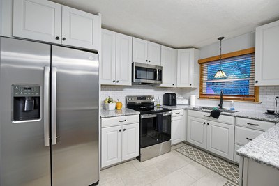87 Snowbird Road Robbinsville, NC 28771 - Photo 12 of 40 a kitchen with stainless steel appliances granite countertop a refrigerator stove a sink and dishwasher with wooden floor