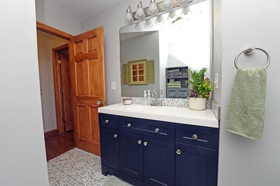 87 Snowbird Road Robbinsville, NC 28771 - Photo 15 of 40 a bathroom with a sink a vanity and mirror