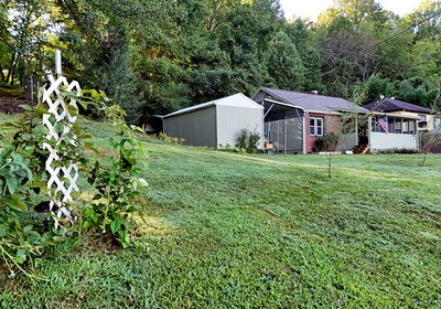 87 Snowbird Road Robbinsville, NC 28771 - Photo 27 of 40 a house that is sitting in the forest