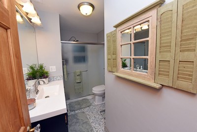 87 Snowbird Road Robbinsville, NC 28771 - Photo 29 of 40 a bathroom with a toilet a sink and shower