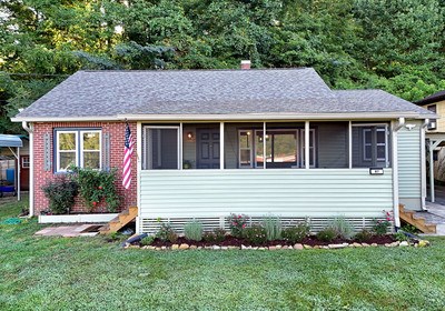87 Snowbird Road Robbinsville, NC 28771 - Photo 3 of 40 a view of a house with a small yard plants and large tree