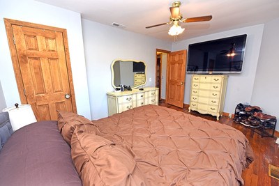 87 Snowbird Road Robbinsville, NC 28771 - Photo 34 of 40 a bedroom with a bed a dresser and flat screen tv
