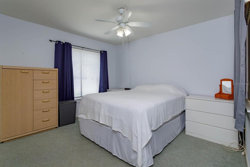 240 Orienta Point Street, Unit 240 Altamonte Springs, FL 32701 - Photo 9 of 20 a bedroom with a bed and a dresser