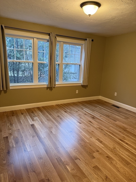 30 Johnson Street, Unit 1 Worcester, MA 01604 - Photo 11 of 24 a view of room with window and wooden floor