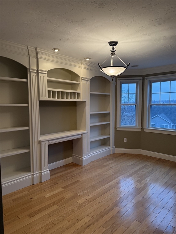 30 Johnson Street, Unit 1 Worcester, MA 01604 - Photo 13 of 24 a view of an empty room with a window and wooden floor