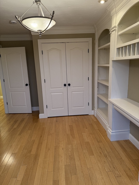 30 Johnson Street, Unit 1 Worcester, MA 01604 - Photo 14 of 24 a view of an empty room with a window and wooden floor