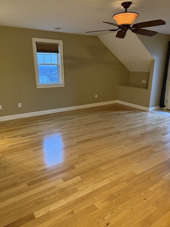 30 Johnson Street, Unit 1 Worcester, MA 01604 - Photo 18 of 24 a view of an empty room with a window and wooden floor