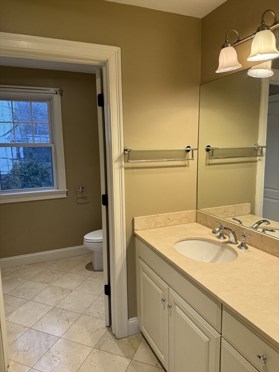 30 Johnson Street, Unit 1 Worcester, MA 01604 - Photo 21 of 24 a bathroom with a sink a toilet and shower