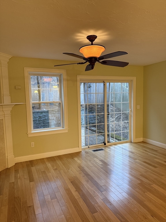 30 Johnson Street, Unit 1 Worcester, MA 01604 - Photo 7 of 24 a view of an empty room with a window and wooden floor