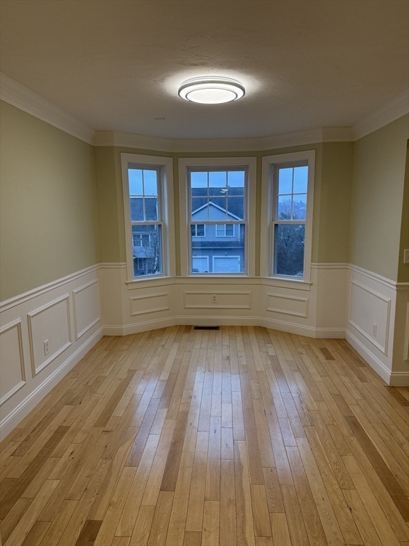30 Johnson Street, Unit 1 Worcester, MA 01604 - Photo 9 of 24 a view of an empty room with wooden floor and a window