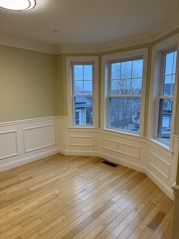 30 Johnson Street, Unit 1 Worcester, MA 01604 - Photo 10 of 24 a view of an empty room with a window and wooden floor