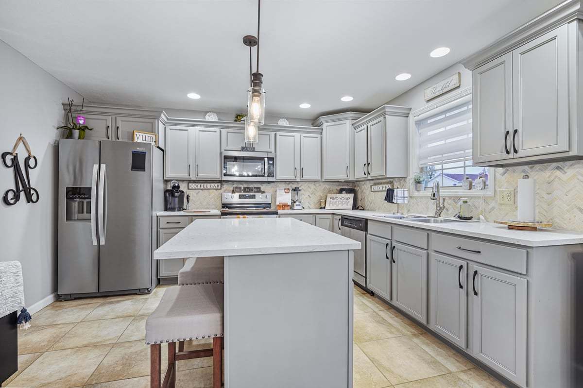 905 Dresser Drive Normal, IL 61761 - Photo 15 of 38 a kitchen with stainless steel appliances kitchen island a refrigerator sink and cabinets