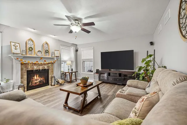 a living room with furniture a fireplace and a flat screen tv