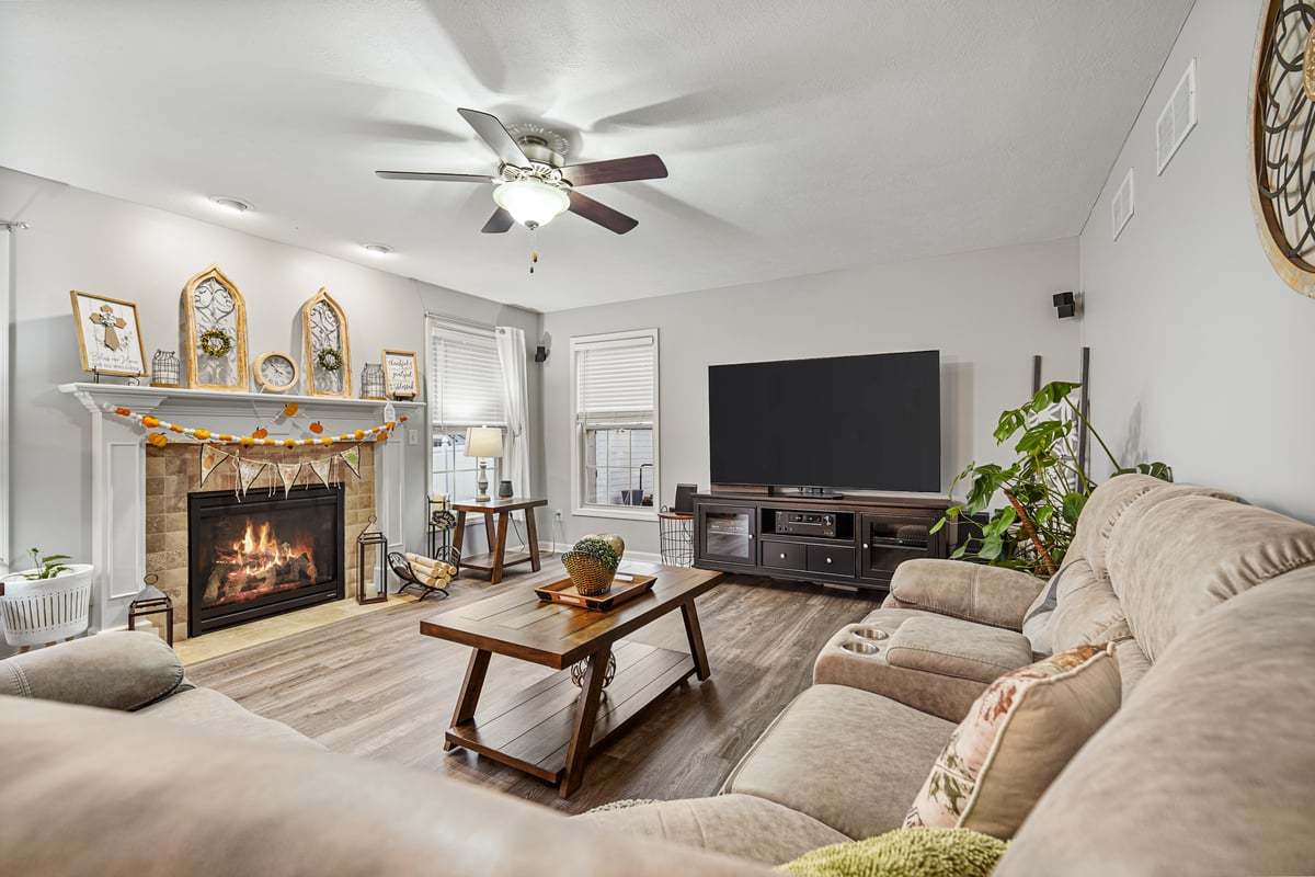 905 Dresser Drive Normal, IL 61761 - Photo 21 of 38 a living room with furniture a fireplace and a flat screen tv