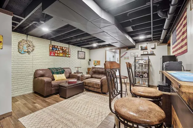 a media room with lots of chairs and a chandelier