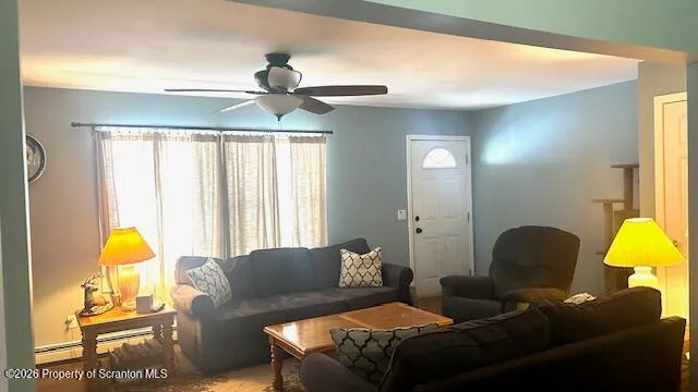 a living room with furniture and a chandelier