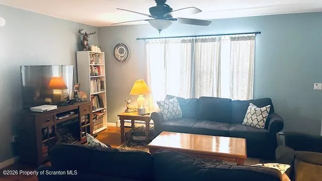 a living room with furniture and a flat screen tv