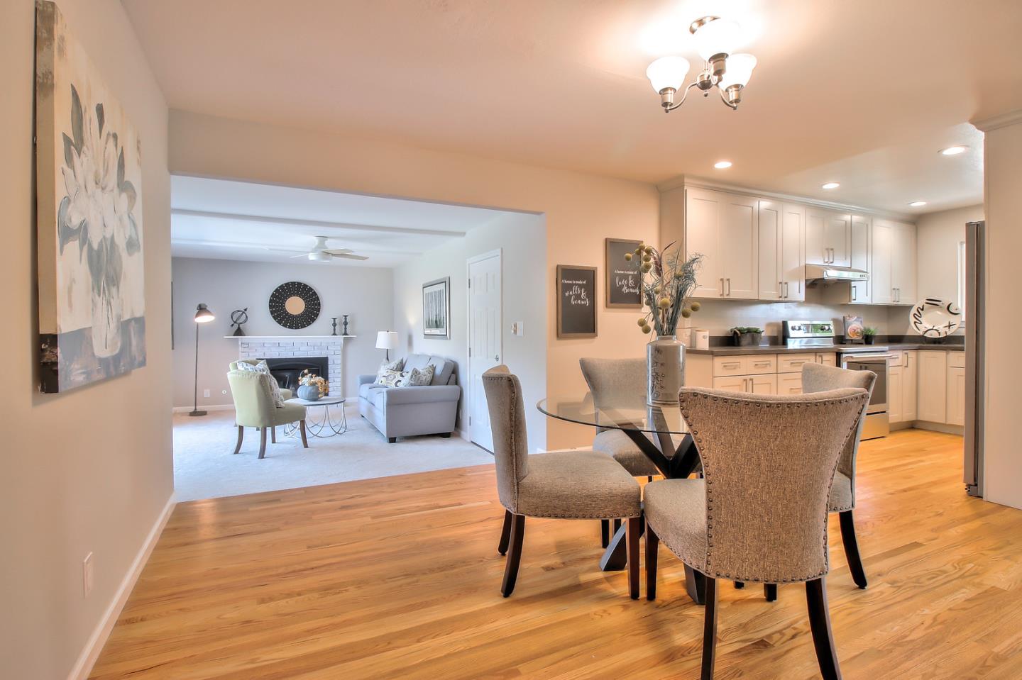 2128 Vía D'Este Campbell, CA 95008 - Photo 12 of 33 a dining room with kitchen island stainless steel appliances furniture a dining table and chairs