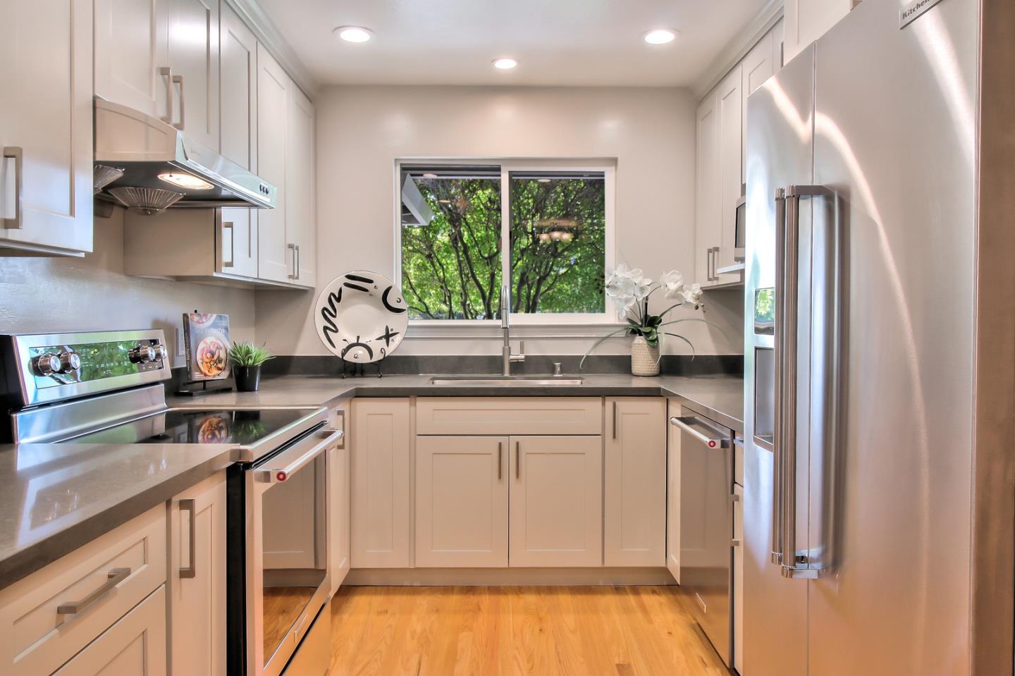 2128 Vía D'Este Campbell, CA 95008 - Photo 16 of 33 a kitchen with stainless steel appliances granite countertop a refrigerator sink and cabinets