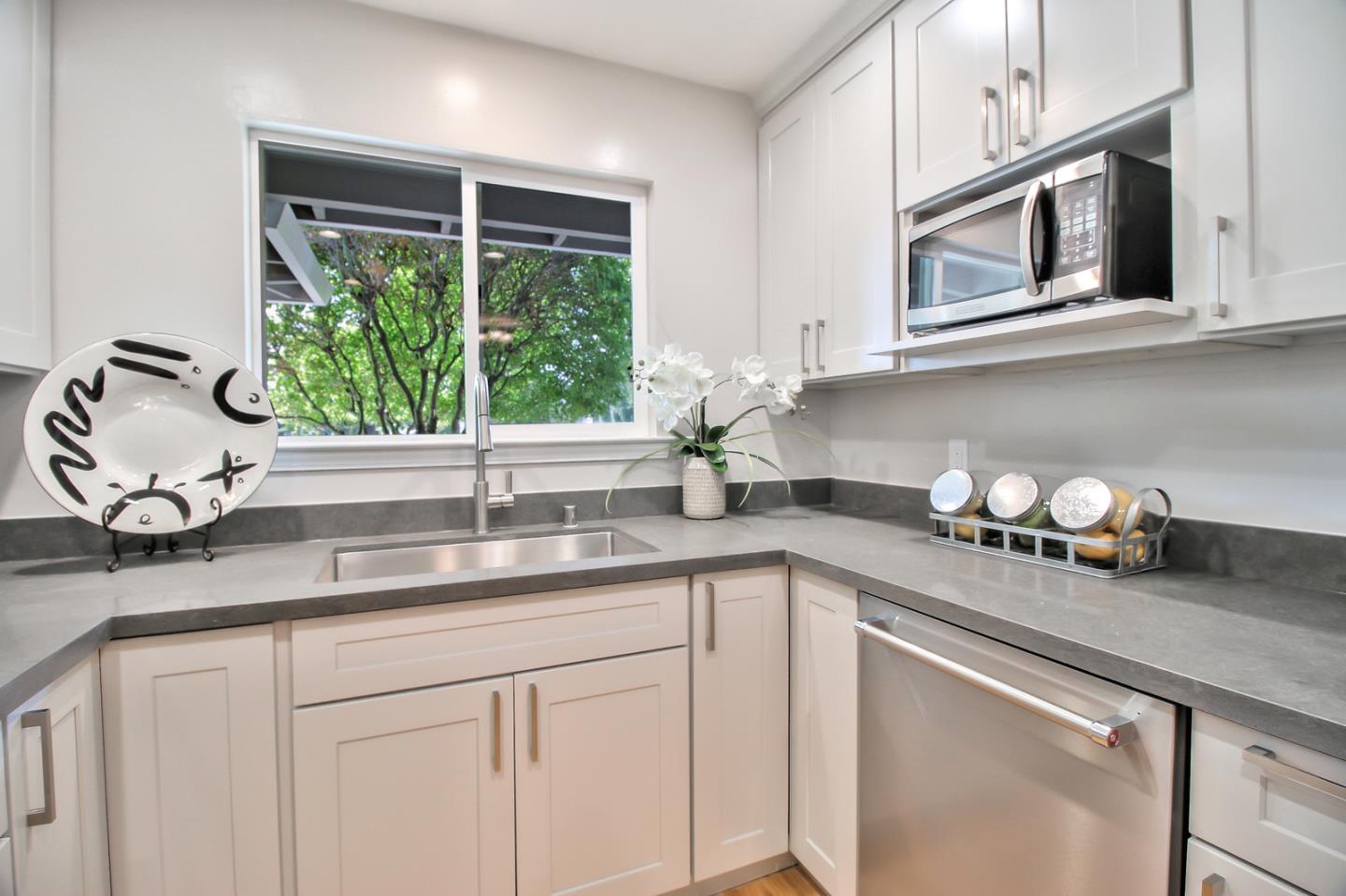 2128 Vía D'Este Campbell, CA 95008 - Photo 17 of 33 a kitchen with stainless steel appliances granite countertop white cabinets a window and a sink