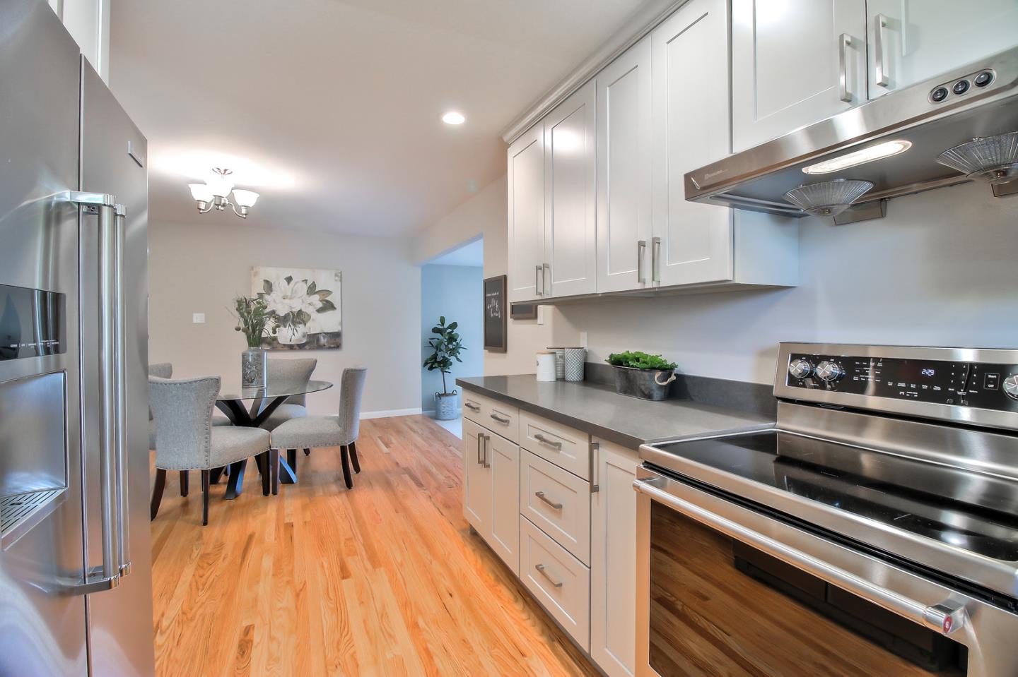 2128 Vía D'Este Campbell, CA 95008 - Photo 18 of 33 a kitchen with stainless steel appliances a stove a sink and cabinets