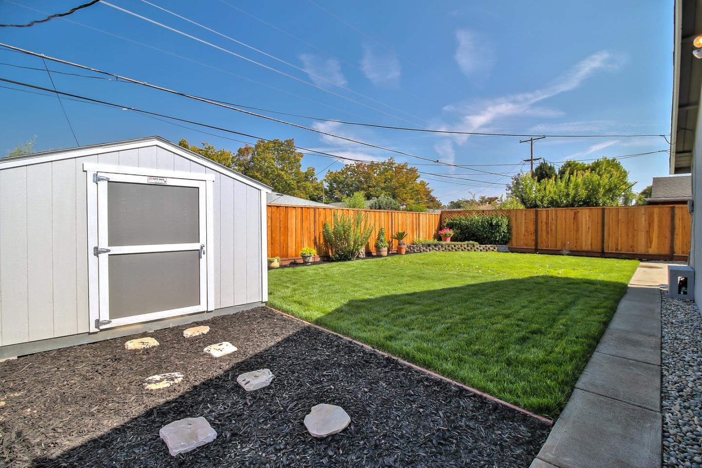 2128 Vía D'Este Campbell, CA 95008 - Photo 33 of 33 a view of a backyard with large trees and a barn