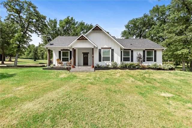 a front view of house with yard and green space