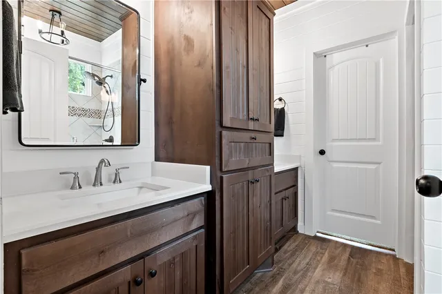 a large kitchen with cabinets a counter space a sink stainless steel appliances and cabinets