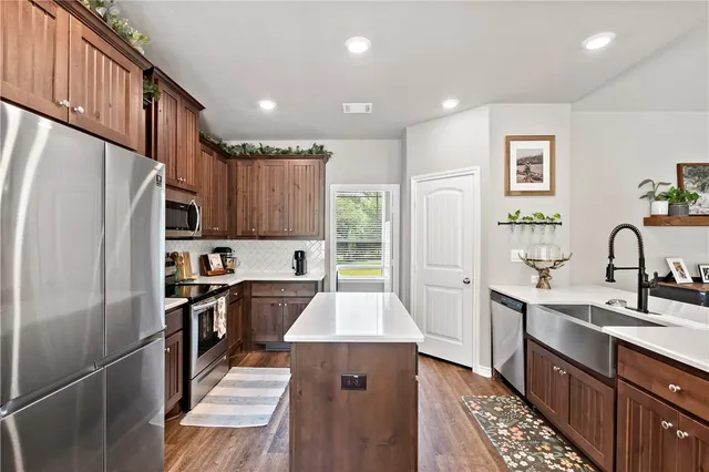 a room with a sink a desk and chair