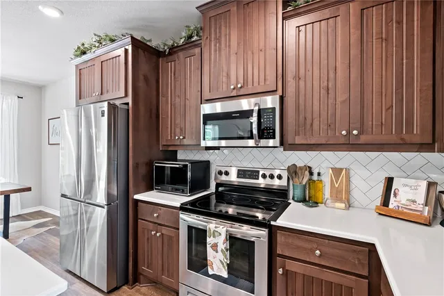 a kitchen with a refrigerator a sink and cabinets