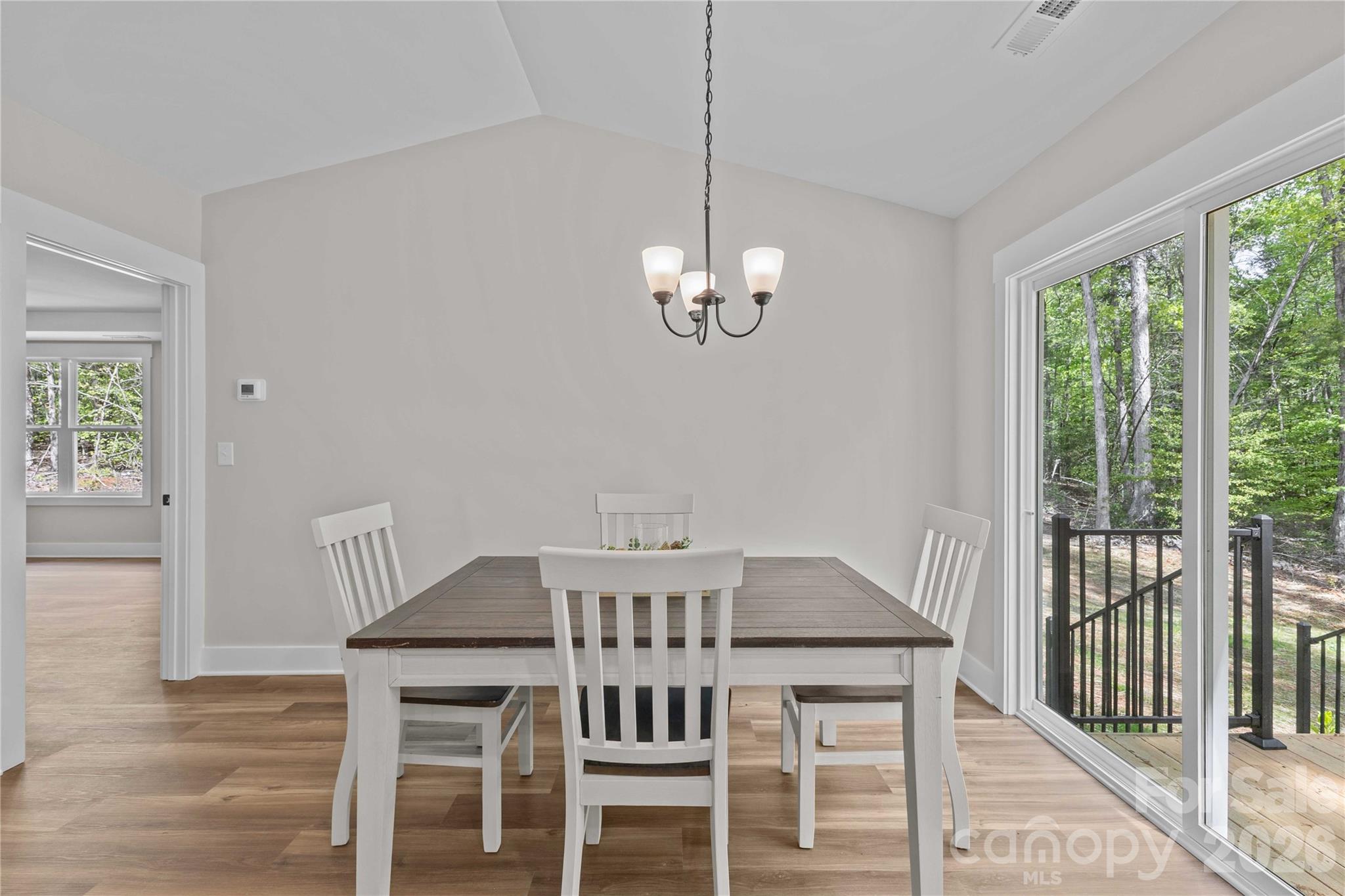 4581 Riverside Road Lancaster, SC 29720 - Photo 23 of 46 a view of a dining room with furniture a chandelier and wooden floor