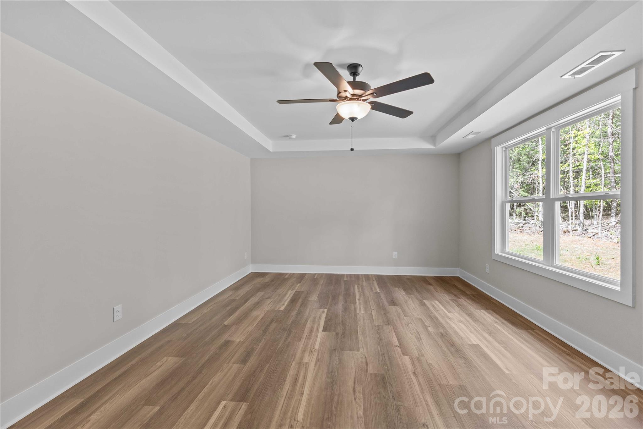 4581 Riverside Road Lancaster, SC 29720 - Photo 25 of 46 an empty room with wooden floor fan and windows