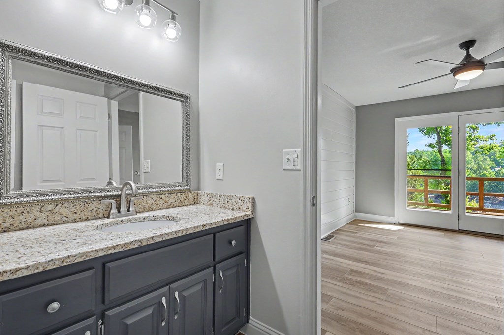 456 Deaver Cove Road Blairsville, GA 30512 - Photo 28 of 83 a bathroom with a granite countertop sink and a mirror