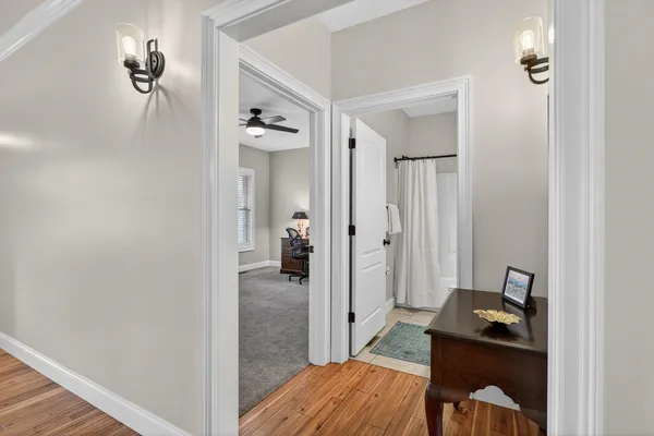 a bathroom with a sink vanity mirror and toilet