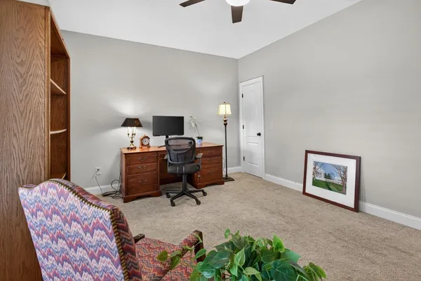 a view of a livingroom with workspace and a window