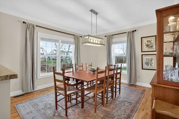 a living room with furniture kitchen view and a large window