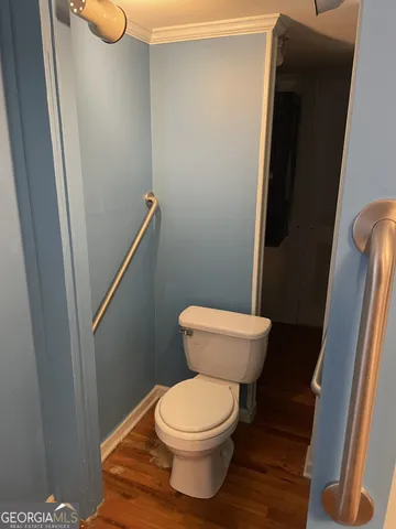 an empty room with wooden floor and white doors