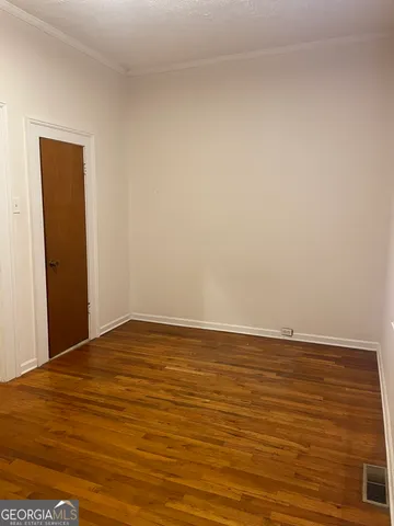 a view of a room with wooden floor and closet