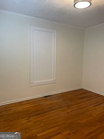 a view of a room that has a bed and a window