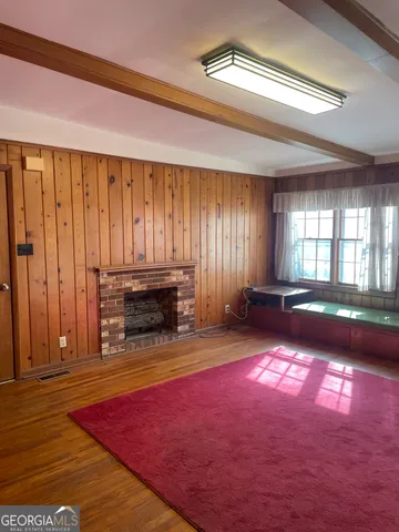 a kitchen with stainless steel appliances granite countertop a sink window and cabinets