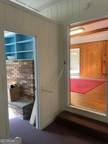 a view of a room with window wooden floor and a fireplace