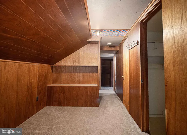 a view of a room with wooden walls