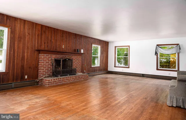 a view of a livingroom with furniture and a fireplace