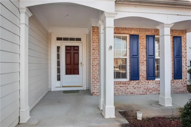 front view of a brick house with a large window