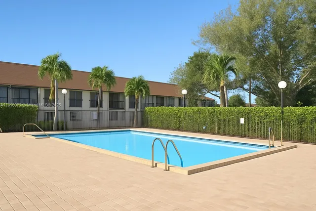 a view of swimming pool and deck in the backyard of house