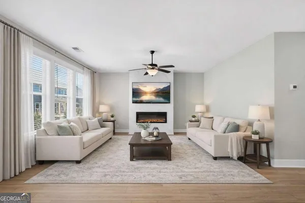 a living room with furniture and a large window