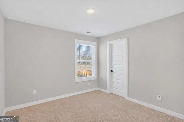 an empty room with windows and closet